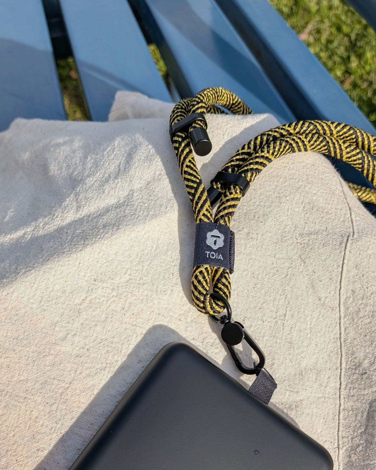 Modern gold and black herringbone crossbody lanyard phone strap by TOIA.